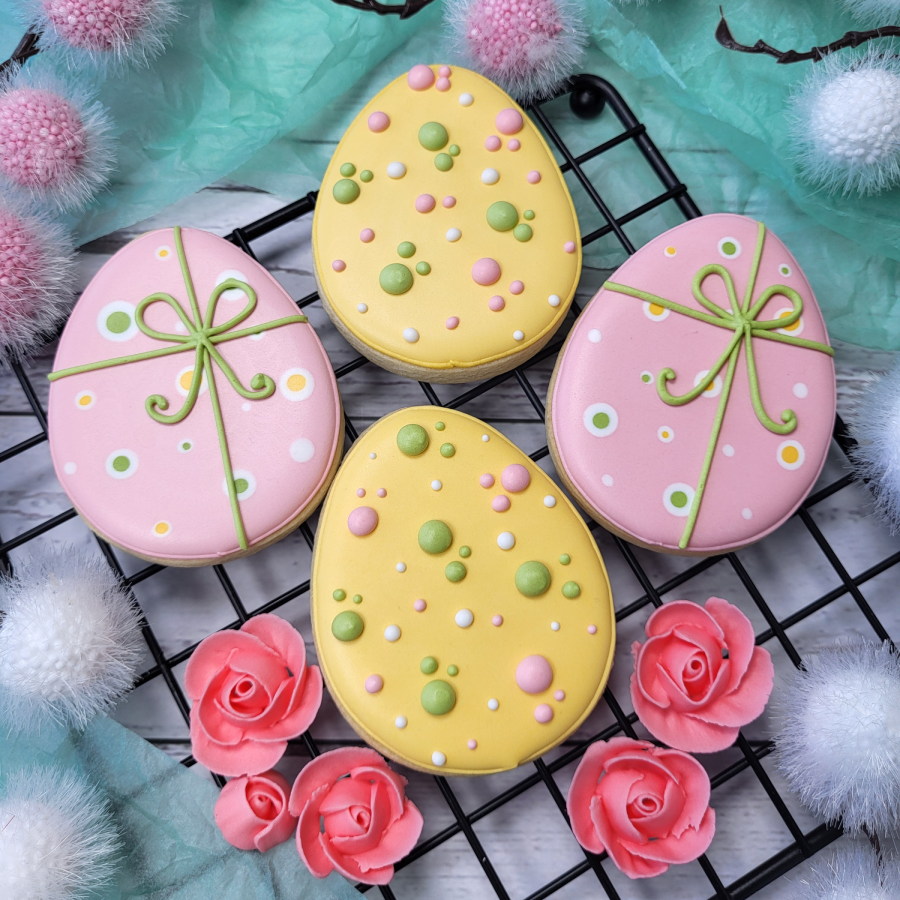 Easter egg royal icing cookies decorated with pastel colors and gift ribbon design